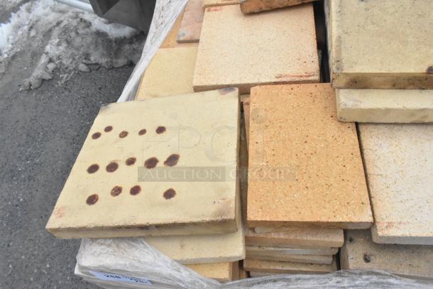 Stack of 200 pizza oven cooking stones, rectangular shape, various colors, some with dark spots, suitable for high-temperature baking.