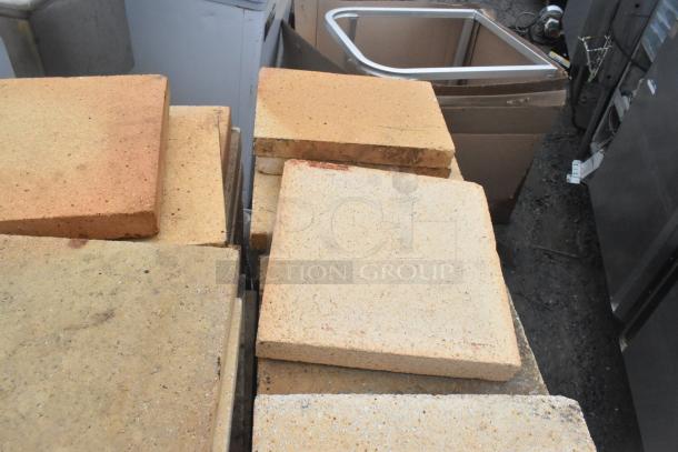 200 pizza oven cooking stones, durable, used condition. Ideal for enhancing pizza baking. Auction includes bulk quantity.