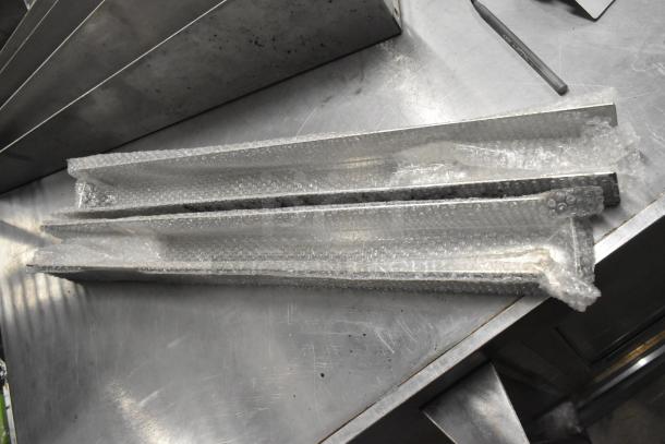 Brand new VacPak-It 186LED12U lid for UVME12SS, microwave door, metal pieces wrapped in bubble wrap on metal surface.