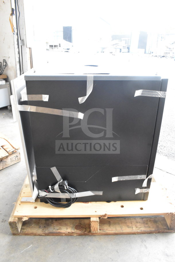BRAND NEW SCRATCH AND DENT Follett ID50 Commercial Ice Machine Head, black, visible tape, on a wooden pallet.
