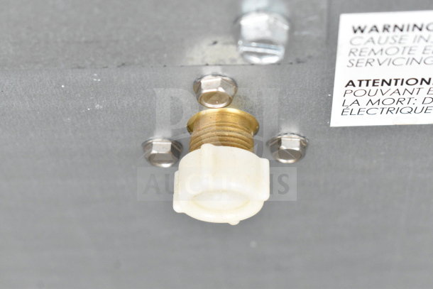 Scotsman RCA3061 remote condenser detail showing brass fittings and warning label. Designed for 2022 CIM1545R/1845R units.