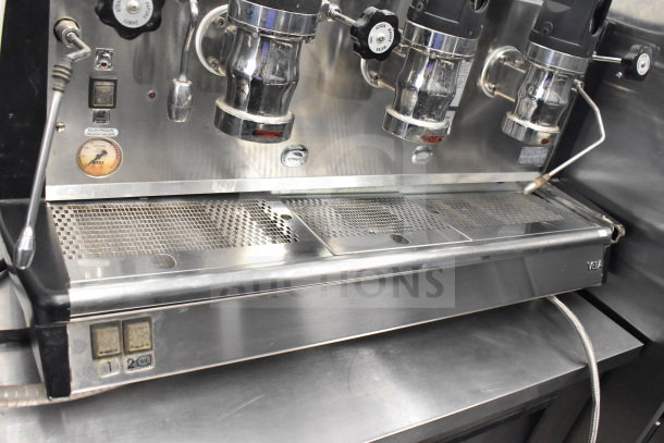 Vela Commercial Countertop 3 Group Espresso Machine with two steam wands, stainless steel, visible wear, gauge, and switch details.