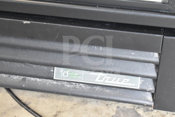 2018 True GDM-12-HC single door cooler, black exterior, visible True logo. 115 Volts, 1 Phase, commercial use.