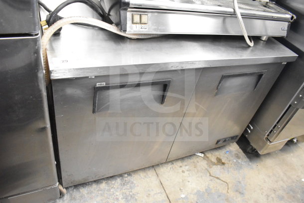 True TUC-48 Commercial 2 Door Undercounter Cooler with casters, 115V, 1 Phase, visible wear on stainless steel surface.