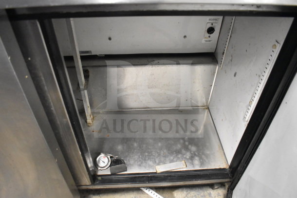 True TUC-48 commercial 2-door undercounter cooler, stainless interior, visible wear, casters, 115V, 1 phase.