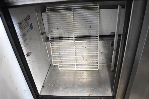 True TUC-48 commercial undercounter cooler, 2 doors, on casters, 115V, 1 phase, visible internal labeling, fair condition.