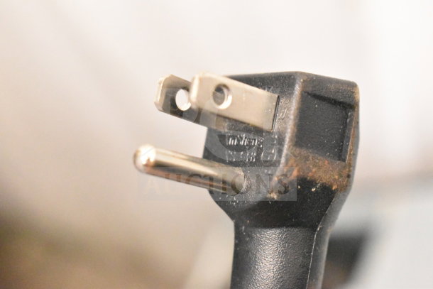 Close-up of a power plug from Euhomy MF-21-Y Mini Freezer, 115 Volts, 1 Phase, showing visible wear on the prongs.
