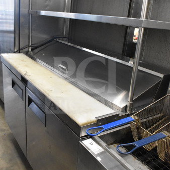 2021 Atosa MSF8303GR commercial sandwich salad prep table with 2 overshelves, stainless steel, 115V, shown with white cutting board.