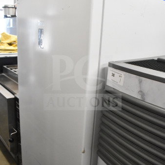 Midea Single Door Reach In refrigerator, 115 volts, 1 phase, white exterior, minor surface wear visible on doors.