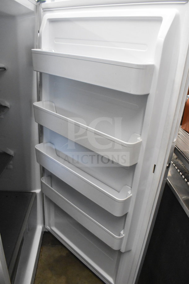 Midea single door reach-in refrigerator interior, four shelves, 115 volts, 1 phase, in good condition.