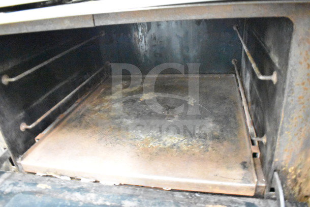 Jade Range commercial 6-burner gas range with salamander cheese melter, used condition, showing interior wear.
