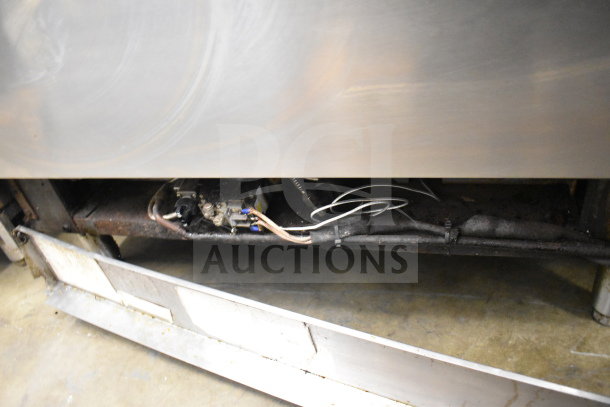 Jade Range 6-burner commercial gas range with salamander cheese melter. Visible wiring and underside shown, moderate wear.