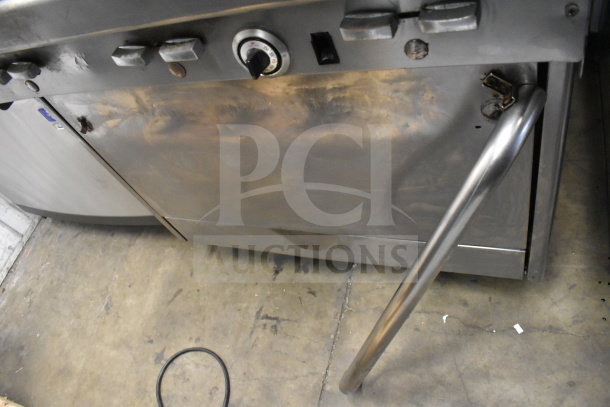 Jade Range commercial gas 6-burner range with salamander cheese melter, in fair condition, visible wear on surfaces.