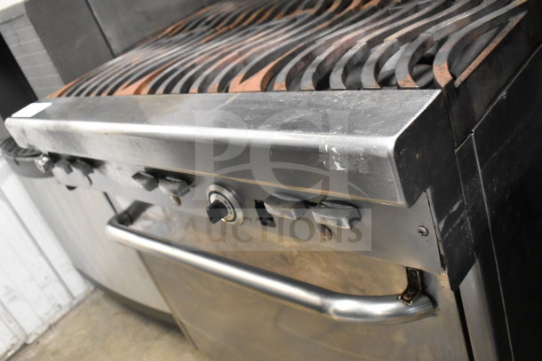 Jade Range commercial gas 6-burner stove with salamander cheese melter, stainless steel, visible wear, robust construction.