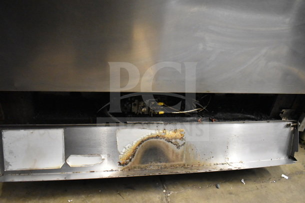 Jade Range commercial 6 burner gas range with salamander cheese melter, showing visible wear and burn marks on stainless steel surface.