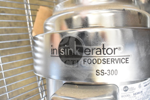Insinkerator SS300-25 commercial garbage disposal, stainless steel, 208/230/460V, 3-phase, visible brand logo and model label.
