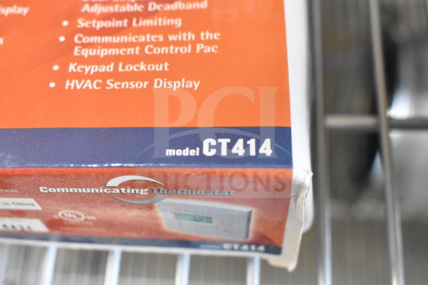 2 Surveyor CT414 commercial thermostats in box, model CT414. Features keypad lockout, HVAC sensor display. New condition.