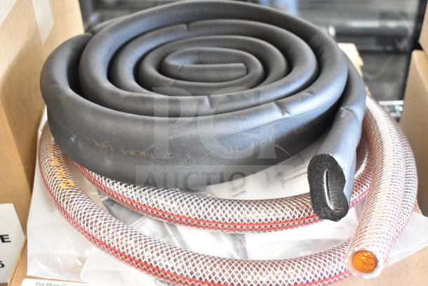 A coiled black rubber hose alongside a braided mesh hose on a surface. Marks indicate model details.