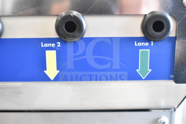 Follett IMDV-2CM Diverter Valve, stainless steel, dual lanes marked Lane 1 and Lane 2, directional arrows, good condition.