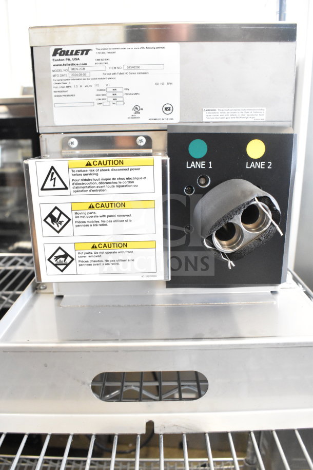 Follett IMDV-2CM Diverter Valve, model IMDV-2CM, featuring caution labels, dual lane ports, and metallic finish, in good condition.