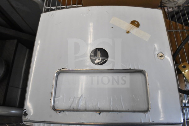 Brand new wall mount unit, visible scratches and dents, metal finish, circular label indicating functionality.