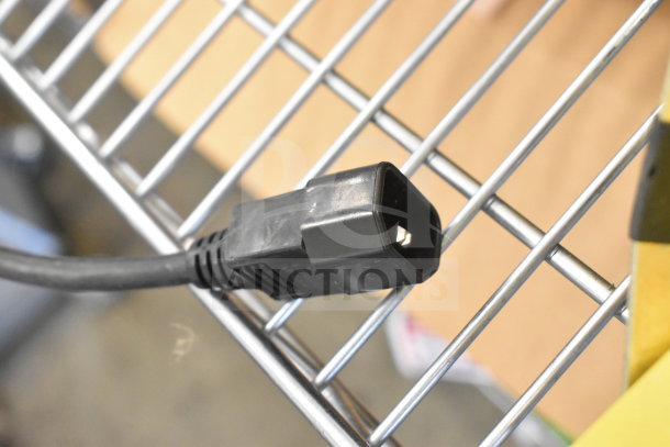 A close-up of the plug of a brand new Rite Hite RH-40-P loading dock light, showing minimal wear from light handling.