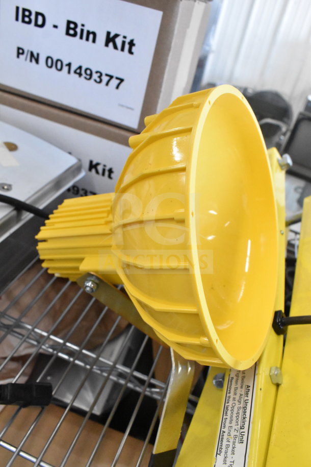 Yellow Rite Hite RH-40-P loading dock light, brand new with minor scratches, on metal shelf.