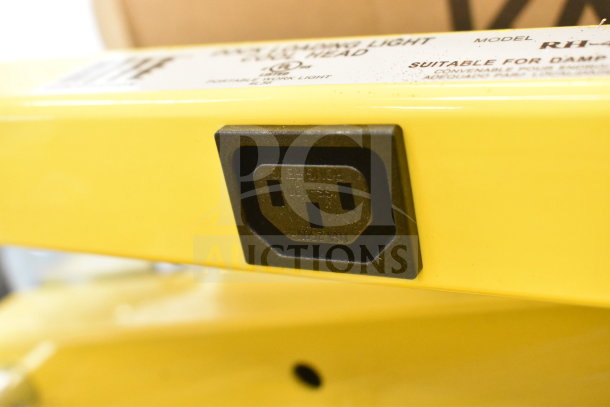 Alt text: Rite Hite RH-40-P loading dock light, yellow, model label indicating suitability for damp locations. Brand new with minor dents.