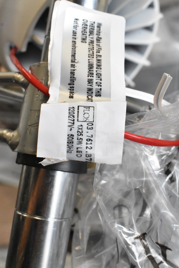 Flos E347601 light fixture with label showing model and LED specifications. Wires and metal parts are visible.