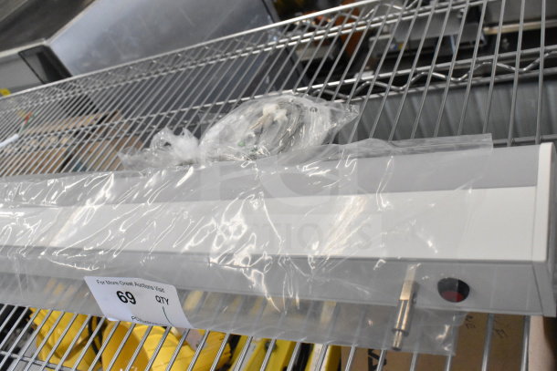 Bartco Lighting light fixture on metal rack, in clear packaging. Includes wiring and installation hardware. Condition appears new.