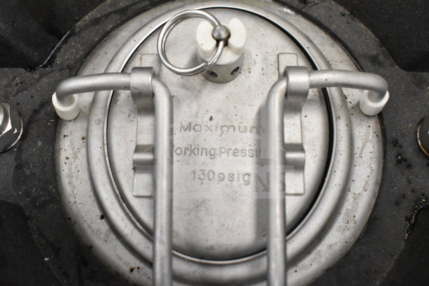 Stainless steel keg labeled "Maximum Working Pressure 130 psig," featuring secure metal latching system.