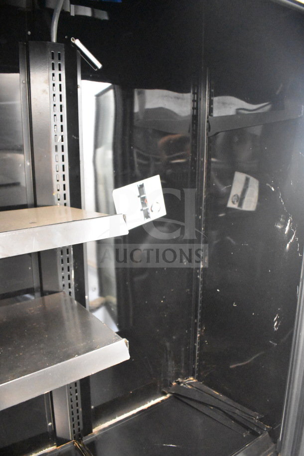 2021 True TVM-48SL-HC commercial cooler, 2-door, reach-in, shelves visible, black interior, good condition.