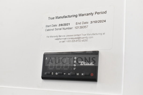 2021 True TSCI-600R-G-PH single door cooler, serial 10139357. Digital display panel and warranty label visible.