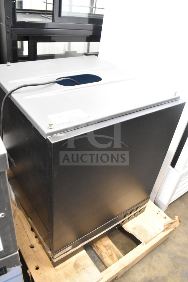 Brand new Follett ID50 commercial ice machine head, scratch and dent condition, black exterior, resting on a pallet.