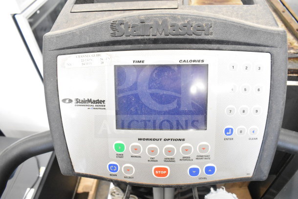 Nautilus StairMaster Stepmill 7000PT, digital console, various workout options, worn condition, visible labels.
