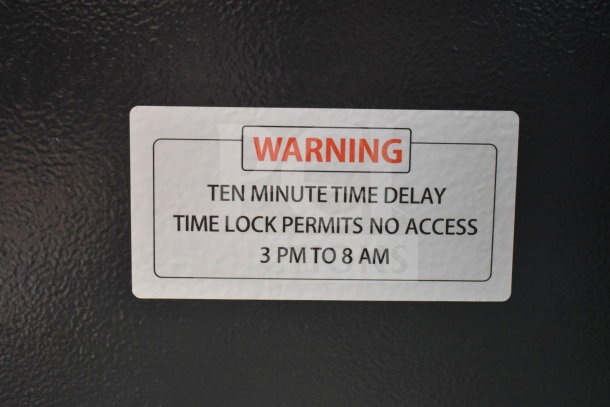 Commercial single compartment safe with warning label. Ten-minute time delay lock. No combination included.