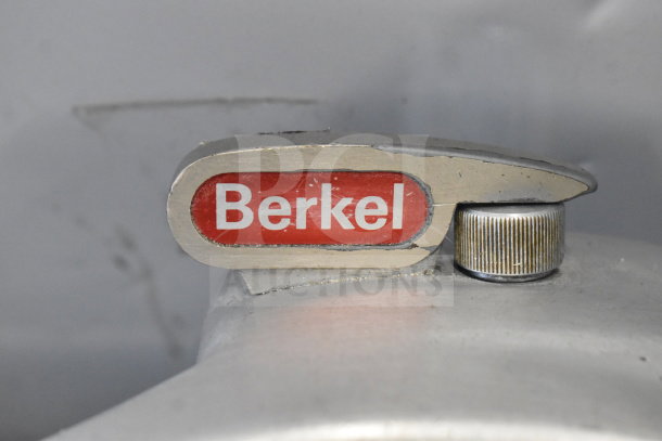 Berkel commercial countertop meat slicer with sharpening blade, 115 volts, 1 phase; visible wear, Berkel logo label.