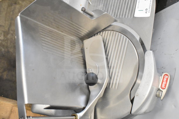 Berkel commercial countertop meat slicer with sharpening blade, 115 volts, 1 phase. Features stainless steel build and Berkel logo.