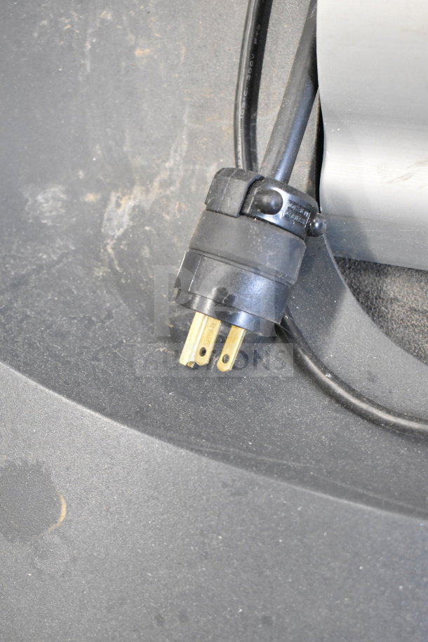 Life Fitness ATV15-XXXA-02 treadmill power plug close-up. Features durable design; minor wear visible.