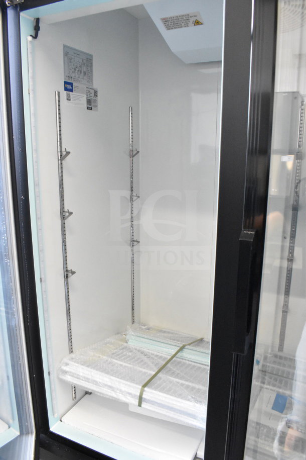 Brand new Avantco 178GDC49FHCB black glass door freezer with LED lighting. Visible labels and shelving inside. 115V, 1 Phase.
