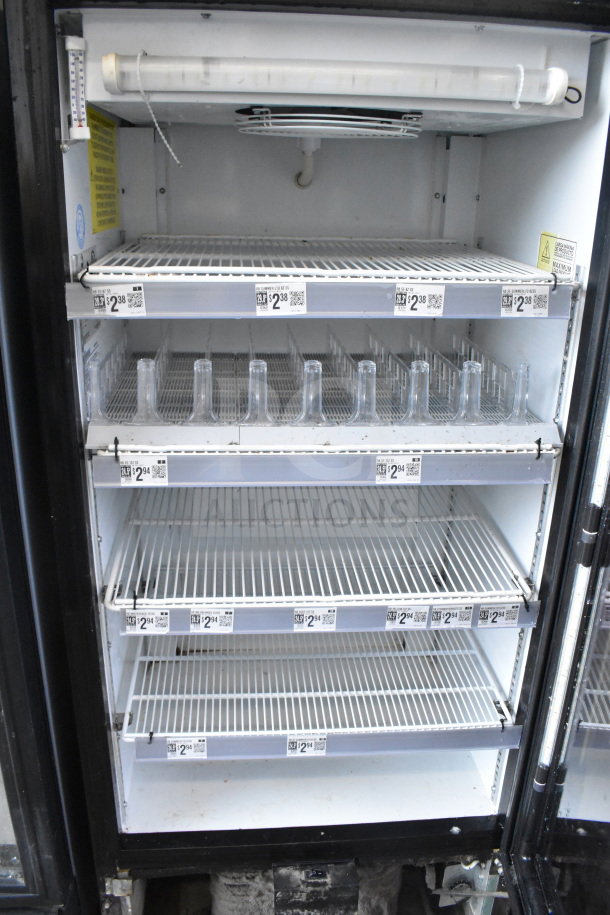 Imbera VR10 commercial single door cooler with four wire shelves, interior lighting, and pricing labels. Model: VR10, 115V.