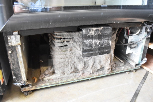 Imbera VR10 Cooler Merchandiser, visible dusty coils and rust on the base, 115V, 1 Phase, potential refurbishment needed.