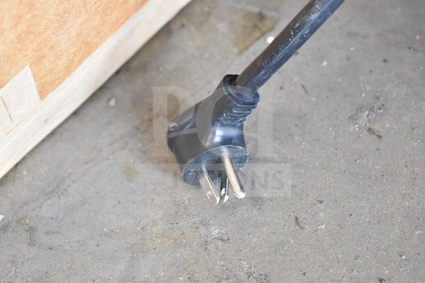 Power plug for 2017 True GDM-12-HC-LD Commercial Cooler Merchandiser, 115 Volts, 1 Phase, shown on a concrete surface.