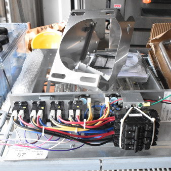 BAYEABC20BK1BAA supplementary electric heater unit, new condition, visible wiring and breaker, includes mounting bracket.