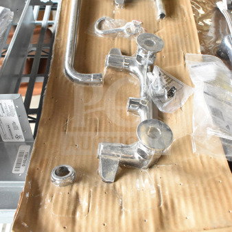 Brand new scratch and dent faucet with handles, chrome finish, includes installation hardware, visible auction label.