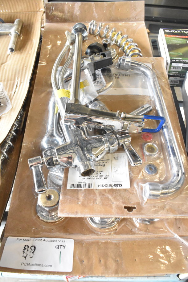 Brand new scratch and dent chrome faucet with handles, includes installation hardware, visible parts in packaging, model KIL5S-7012-SFA.