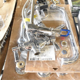 Brand new scratch and dent chrome faucet with handles, includes installation hardware, visible parts in packaging, model KIL5S-7012-SFA.