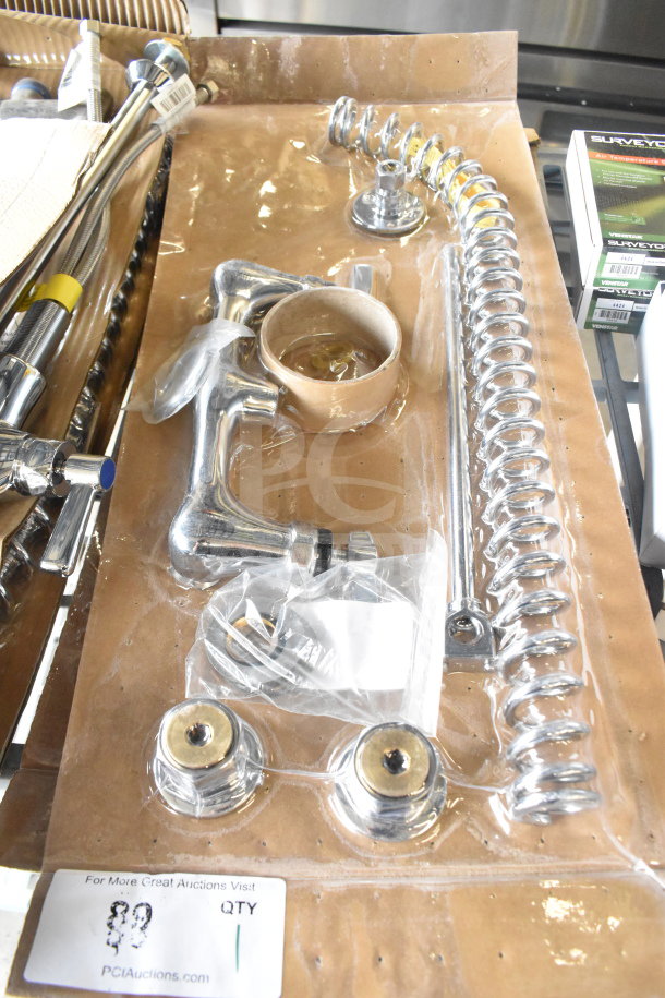 Brand new faucet with handles, scratch and dent condition, chrome finish, includes mounting hardware and spiral spring.