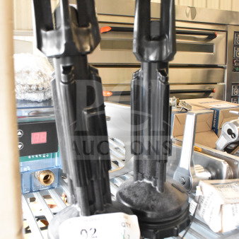 Two black industrial units with cylindrical bases and elongated tops, labeled "QTY x2," on metal shelving.