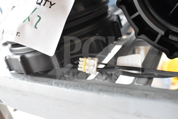 Two black plastic units with visible connectors, labeled "Qty x2," resting on a metal shelf, indicating auction item.